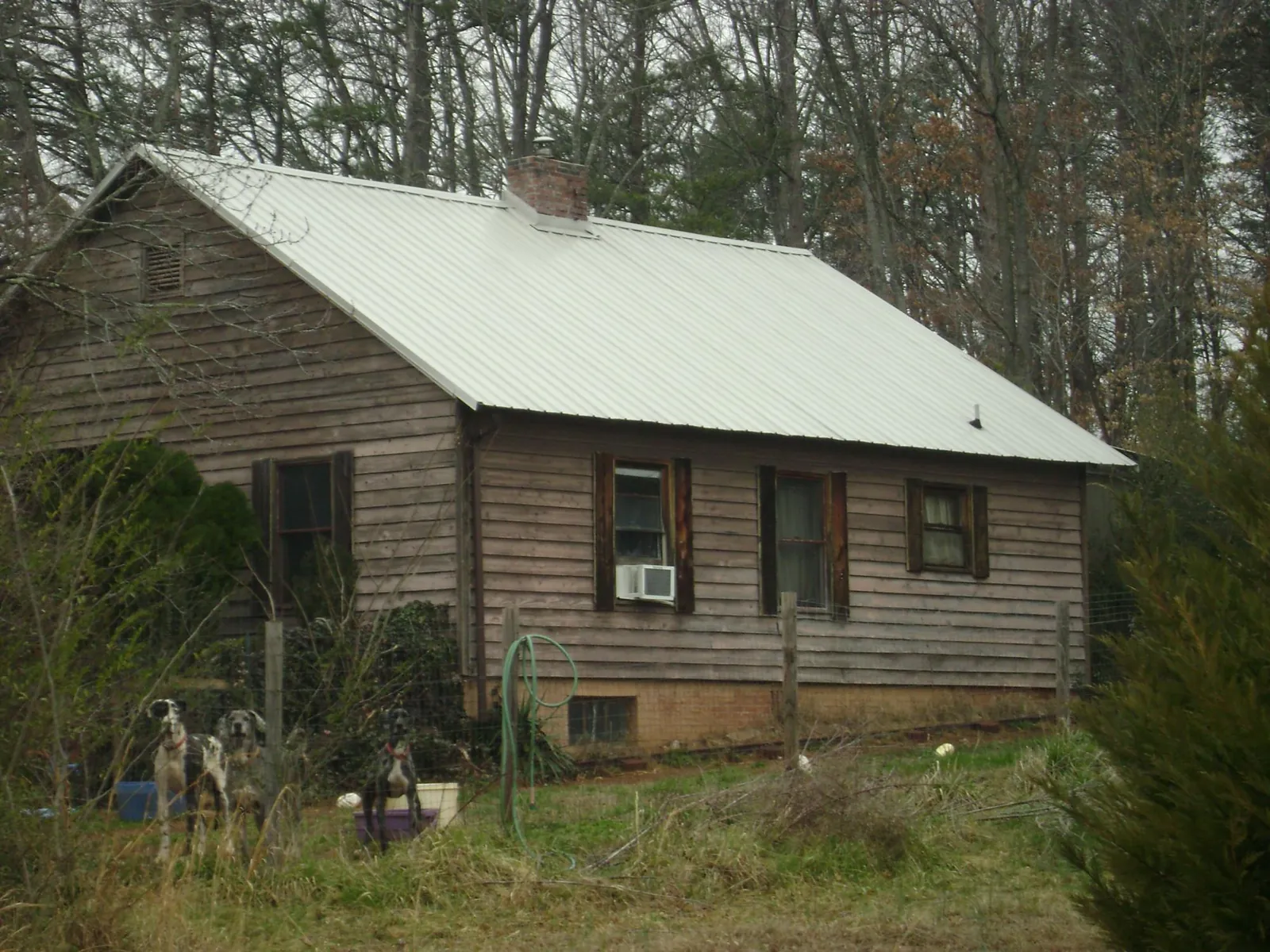 White metal roof on an old wood sided farmhouse in Wilton